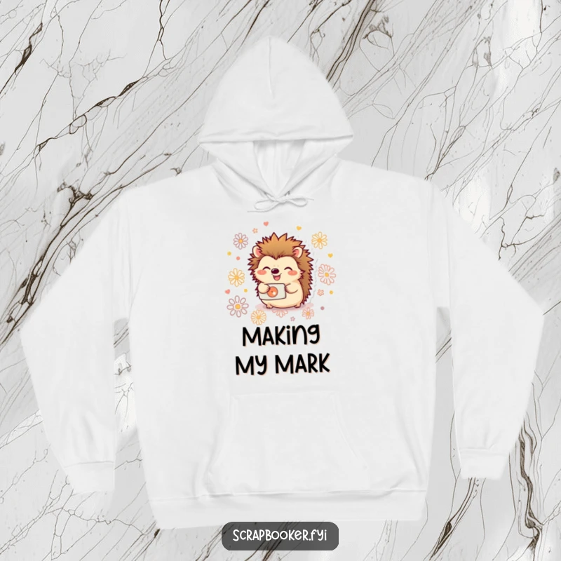 Funny hoodie showcasing a joyful hedgehog using a hole punch to create decorative patterns, ideal for crafters.