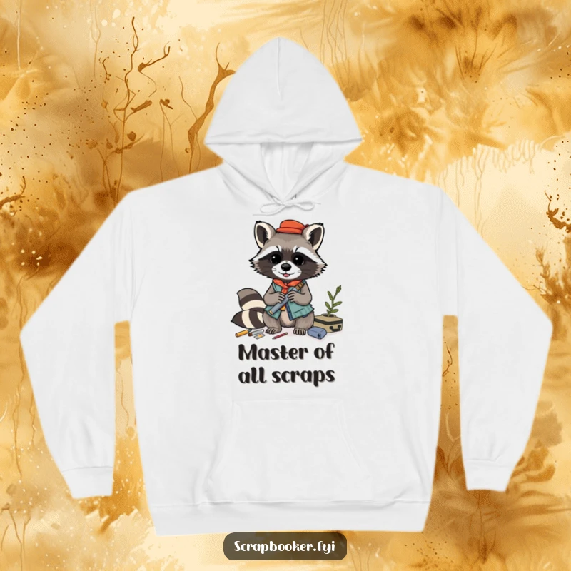 Funny raccoon hoodie, playfully crafting a layered collage from various materials, offering cozy artistic inspiration.