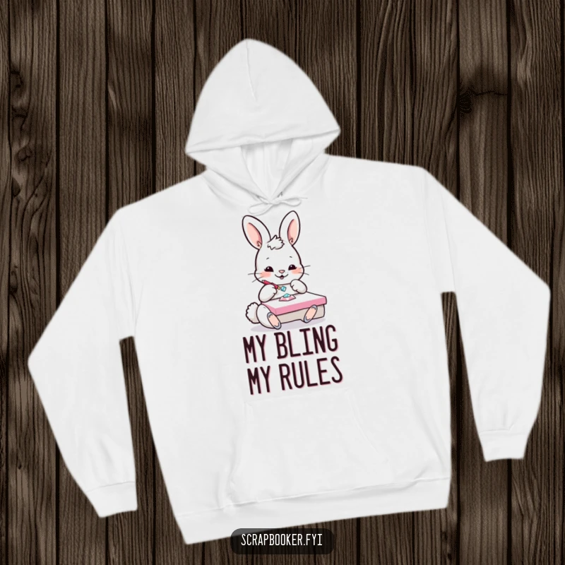 Funny Bunny Hoodie: A playful bunny is engrossed in gluing a sparkling gem onto a crafting project, looking delighted.